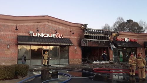 The blaze destroyed a business and damaged three others.