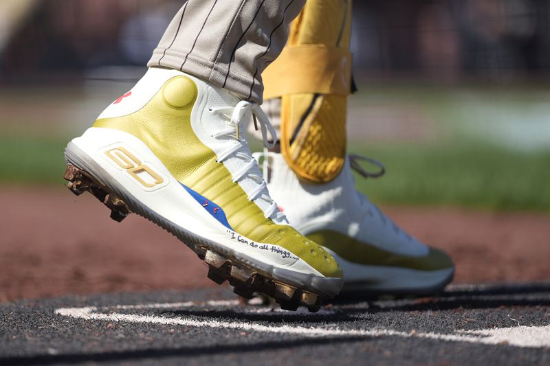FILE - The cleats of San Diego Padres' Fernando Tatis Jr. are shown during the sixth inning of a baseball game against the San Francisco Giants in San Francisco, Friday, April 5, 2024. Tatis plans to unveil 50 pairs of custom cleats this season in conjunction with his branding company, Xample, and Los Angeles-based Shoe Surgeon. The cleats will honor people, events and whatever strikes the 25-year-old Tatis' fancy. (AP Photo/Eric Risberg, File)