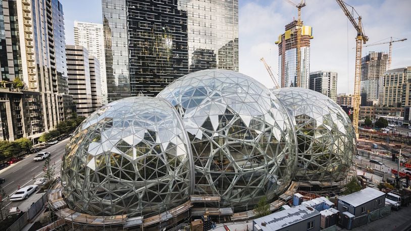 Amazon Tower II rises above the Amazon Biospheres in Seattle. Amazon has been on a building boom in Seattle, but it put a big project there on pause. The company’s reasoning should give a different kind of pause to Georgia, Atlanta and any other locale yearning to land Amazon HQ2, the online giant’s plan for a 50,000-job second headquarters. (Christopher Miller/The New York Times)