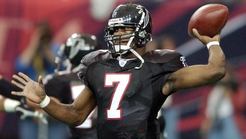 021020 ATLANTA:—Falcons quarterback Michael Vick makes a pass during 2nd half action as he leads his team to a 30-0 victory over the Carolina Panthers in the Georgia Dome on Sunday, Oct. 20, 2002. (CURTIS COMPTON/staff)