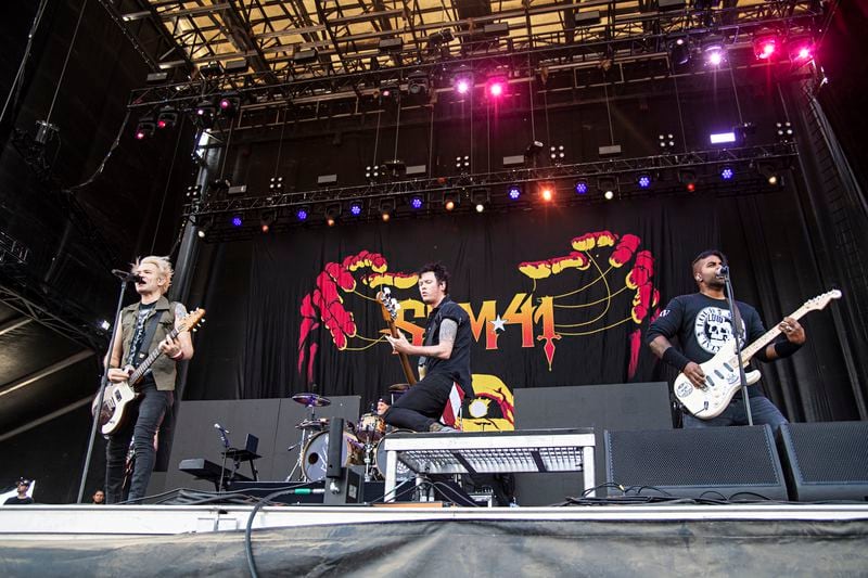 Deryck Whibley, from left, Jason McCaslin, and Dave Baksh of Sum 41 perform during Louder Than Life at Highland Festival Grounds at KY Expo Center on Sunday, Sept. 29, 2019, in Louisville, Ky. (Photo by Amy Harris/Invision/AP)