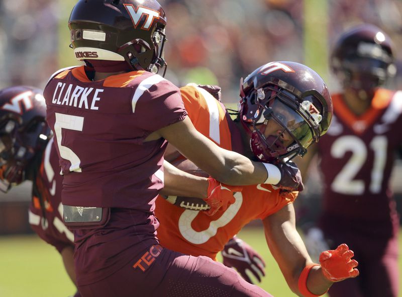 Orange team wide receiver Ali Jennings (0) is stopped short of the end zone by Maroon team defender Joshua Clarke (5) after catching a pass from quarterback William "Pop" Watson III during Virginia Tech's NCAA college football spring game, Saturday, April 13, 2024, Blacksburg, Va. (Matt Gentry/The Roanoke Times via AP)