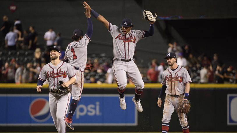 Braves Ender Inciarte (from left), Ozzie Albies, Ronald Acuna and Dansby Swanson celebrate after defeating the Arizona Diamondbacks Saturday, May 10, 2019, at Chase Field in Phoenix. The Braves ended a 10-day road trip 6-4.