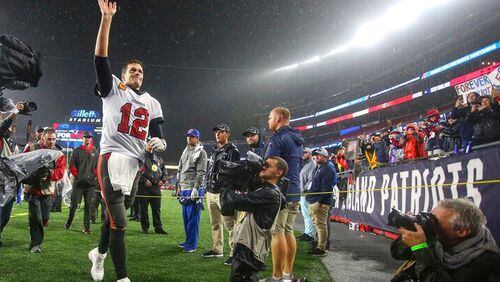 Tampa Bay Buccaneers quarterback Tom Brady (12) waves to the crowd as he runs off the field following an NFL football game against the New England Patriots, Sunday, Oct. 3, 2021, in Foxborough, Mass. (AP Photo/Stew Milne)