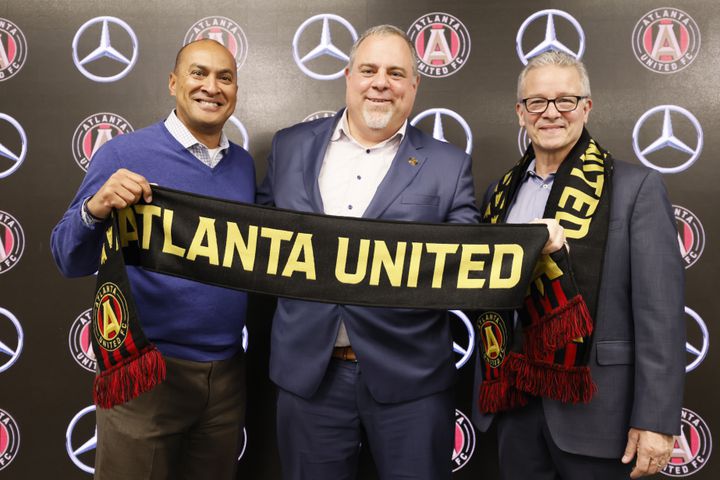 Atlanta United CEO/President Garth Lagerwey (center) poses with AMB Sports and Entertainment CEO Steve Cannon (right) and Chief Human Resources Officer Tim Goodly on Tuesday in Atlanta. (Miguel Martinez / miguel.martinezjimenez@ajc.com)