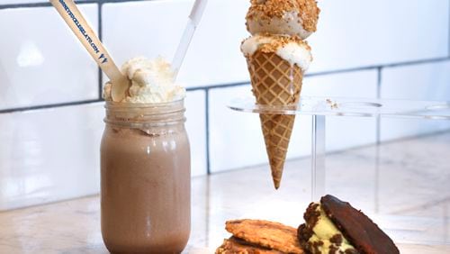 The Honeysuckle Gelato shop at Ponce City Market sells shakes, scoops and sandwiches. The shake was made with a scoop of dark chocolate and a scoop of bourbon gelato, then topped with whipped cream. There are chocolate chip and brown sandwiches, and a cone of brown butter gelato and honey fig gelato, topped with amaretti crumbles.