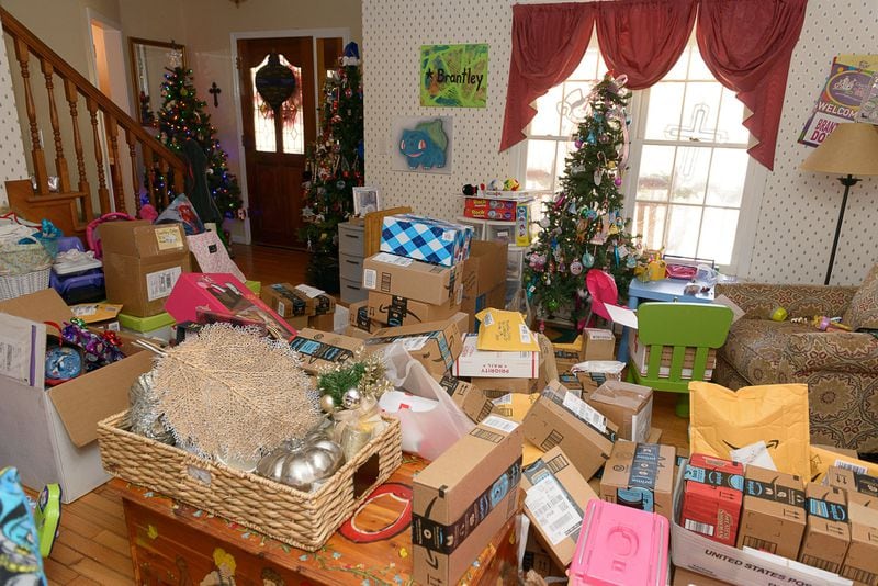 With 50 packages arriving daily from around the world, the Dobbs living room, in Hiram, has become crowded with ornaments and other goodies. CONTRIBUTED BY JEFF GARTIN PHOTOGRAPHY