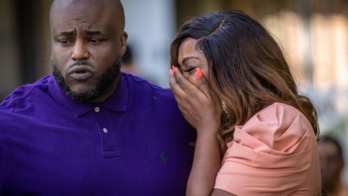 The parents of Nygil Cullins, Dr. Mya Speller Cullins (right) and Quinten Cullins, become emotional while talking at a news  conference Friday.