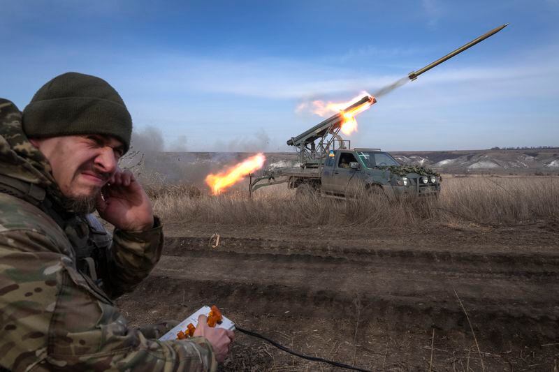 FILE - A Ukrainian officer from The 56th Separate Motorized Infantry Mariupol Brigade fires a multiple launch rocket system based on a pickup truck towards Russian positions at the front line, near Bakhmut, Donetsk region, Ukraine, Tuesday, March 5, 2024. The outgunned and outnumbered Ukrainian troops are increasingly struggling to halt Russian advances as a new U.S. aid package has remained stuck in Congress. (AP Photo/Efrem Lukatsky, File)