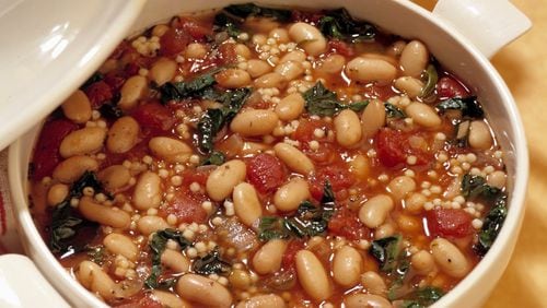 This tomato-bean soup is made with chard and Parmesan, and is served over pasta. (Bob Fila/Chicago Tribune/TNS)