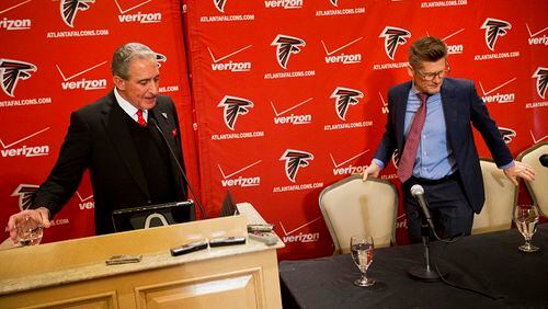 Atlanta Falcons owner Arthur Blank, left, and general manager Thomas Dimitroff leave a news conference after announcing that Mike Smith has been fired as head coach, Monday, Dec. 29, 2014, in Atlanta. (AP Photo/David Goldman) Are they playing musical chairs in Flowery Branch? (David Goldman/AP photo)