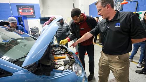 MOPAR CAP Program Director Andy Lindman (right) instructs automotive technology student Michael Cheek of Lilburn as he performs a safety demonstration on a FIAT 500e in the EV Automotive Lab at Gwinnett Technical College on Wednesday, Oct. 18, 2023, in Lawrenceville. In this guest column, the commissioner of the Technical College System of Georgia and Georgia's state school superintendent highlight the state's Career, Technical and Agricultural Education programs. (Jason Getz / Jason.Getz@ajc.com)
