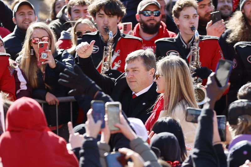 Georgia head coach Kirby Smart gives thumbs up to the fans as he walks through the  Dawg Walk during the victory parade in Athens on Saturday, January 14, 2023. The Bulldogs are the first back-to-back champions in the College Football Playoff era.  Miguel Martinez / miguel.martinezjimenez@ajc.com
