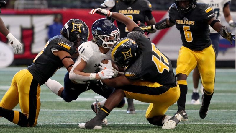 Peach County's Sergio Allen (45) helps bring down Cedar Grove wide receiver Jadon Haselwood (11) during the Class AAA State Championship Tuesday, Dec. 11, 2018, at Mercedes-Benz Stadium in Atlanta.