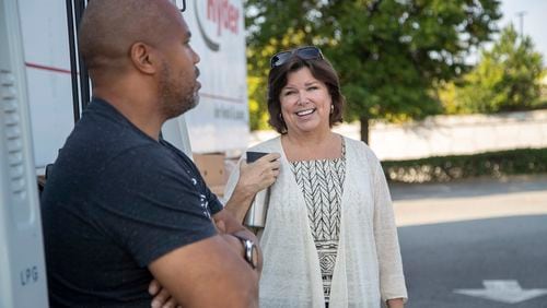 Shari Martin, president and CEO of the Cobb Community Foundation, speaks with a volunteer at the Cobb Community Food Fleet Distribution in Atlanta on September 14, 2021. (Atlanta Journal Constitution file)