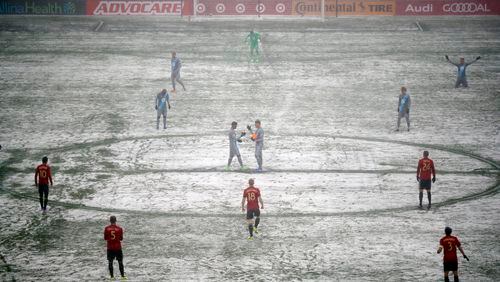 Atlanta United and Minnesota United prepare for an MLS soccer game as a grounds crew worker clear lines Sunday, March 12, 2017, in Minneapolis, Minn. (Jeff Wheeler/Star Tribune via AP)