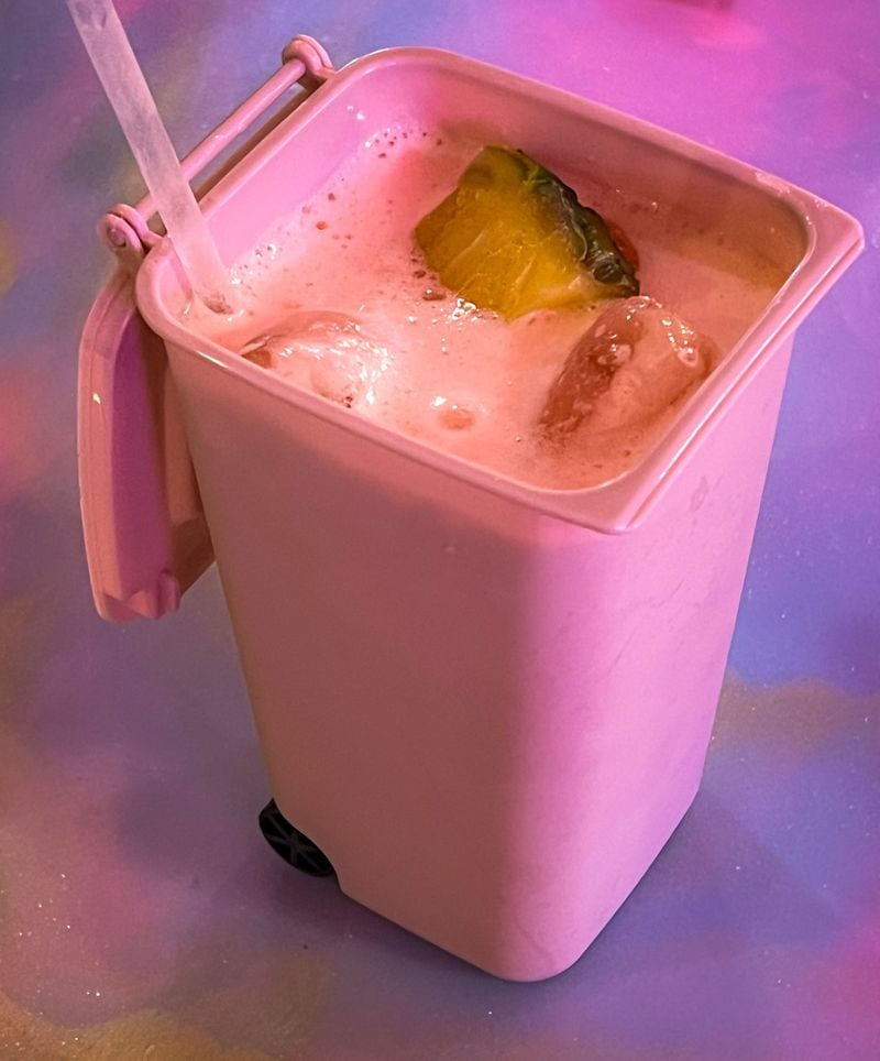 Pretty Little Tacos serves a pink rum punch in a miniature replica of a roll-away trash can. Henri Hollis/henri.hollis@ajc.com