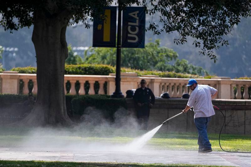 FILE - A man power washes the ground as the cleanup continues on the site of a pro-Palestinian encampment, cleared by police overnight, on the UCLA campus, Thursday, May 2, 2024, in Los Angeles. The only thing more American than protests for a cause? Wanting them to pipe down and go away. From the Boston Tea Party to the Civil Rights Movement to last week, U.S. history is filled with the tension between people demonstrating about issues that matter to them and others who want to be left alone. (AP Photo/Mark J. Terrill, File)