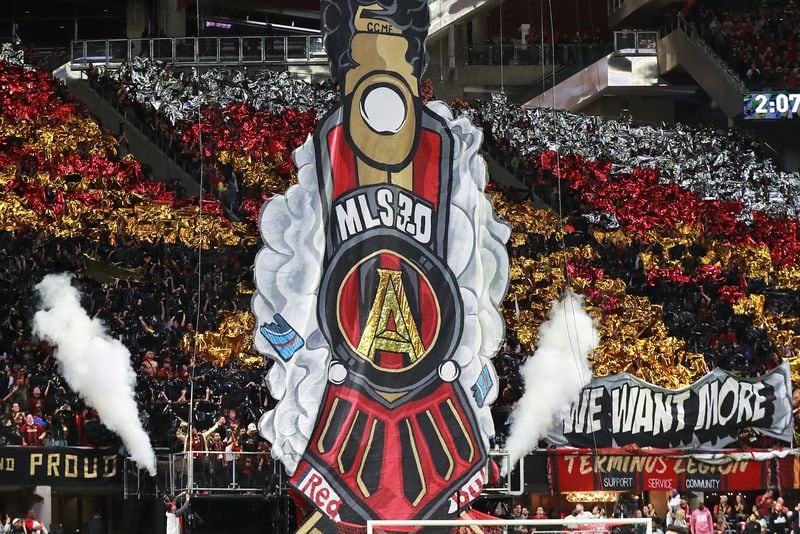 12/8/18 - Atlanta -  Atlanta United fans hoist a tifo to begin the match against the Portland Timbers for the MLS Cup, the championship game of the Major League Soccer League at Mercedes-Benz Stadium in Atlanta.   CURTIS COMPTON / CCOMPTON@AJC.COM