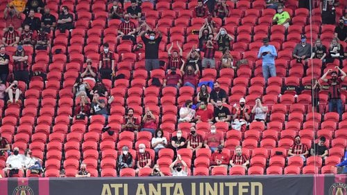 Atlanta United fans cheer for the team during the second half in a MLS soccer match at Mercedes-Benz Stadium in Atlanta on Saturday, October 24, 2020. D.C. United won 2-1 over the Atlanta United. (Hyosub Shin / Hyosub.Shin@ajc.com)