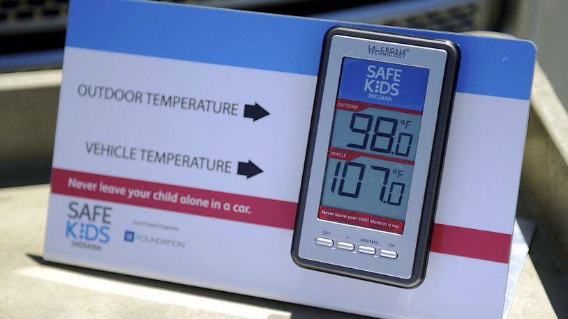 In this July 30, 2015 file photo, St. Mary s and Safe Kids Coalition uses a wireless monitor to record the temperature outside and inside of a closed vehicle at St. Mary s Market Days in Evansville, Ind. A proposed new law that would require carmakers to build alarms for backseats is being pushed by child advocates who say it will prevent kids from dying in hot cars. (Darrin Phegley/Evansville Courier & Press via AP, File)