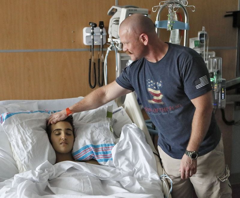 May 30, 2019 - Atlanta - Randall Droke spends some time with his son, Logan, in his hospital room. Logan, 18, from Canton, facing his fourth battle with leukemia at Children’s Healthcare of Atlanta at Scottish Rite, is set to graduate from Creekview High School on Friday. Firefighters in two departments are rallying behind the teenager by raising money to help pay for treatments. Bob Andres / bandres@ajc.com