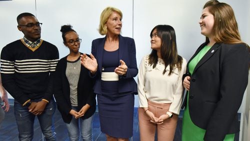 U.S. Secretary of Education Betsy DeVos (center) greets GSU students (from left) Donte Brown, Amila Shake, Jenny Pham and Leila Collins after they took a group photograph during Georgia State University tour and roundtable discussion with students at GSU on Tuesday, Nov. 28, 2017. HYOSUB SHIN / HSHIN@AJC.COM