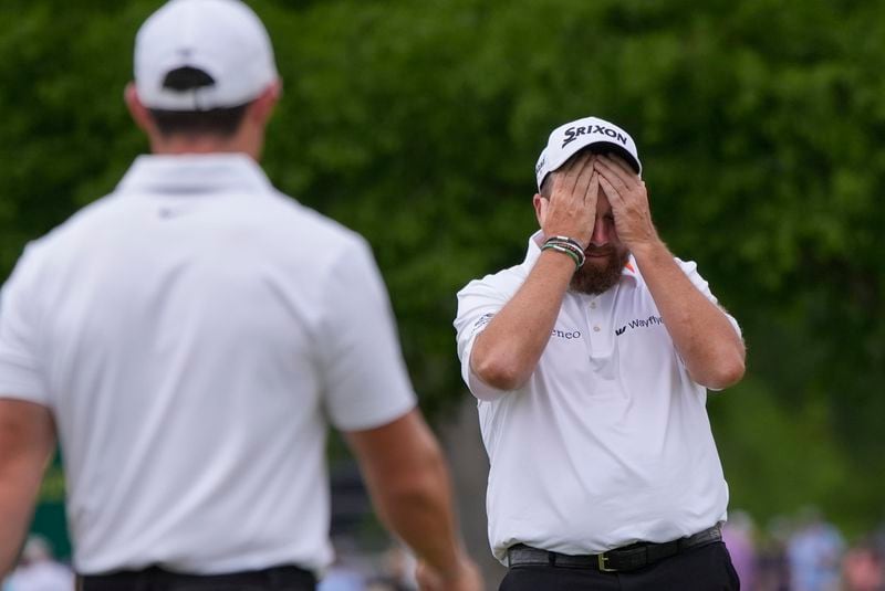 Rory McIlroy, of Northern Ireland, left, approaches teammate Shane Lowry, of Ireland, as he reacts after bogeying the third hole during the final round of the PGA Zurich Classic golf tournament at TPC Louisiana in Avondale, La., Sunday, April 28, 2024. (AP Photo/Gerald Herbert)