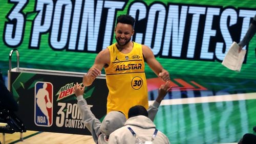 Golden State Warriors guard Stephen Curry reacts to sinking his last shot to win the 3-Point Contest during NBA All-Star night Sunday, March 7, 2021, at State Farm Arena in Atlanta. (Curtis Compton/ccompton@ajc.com)