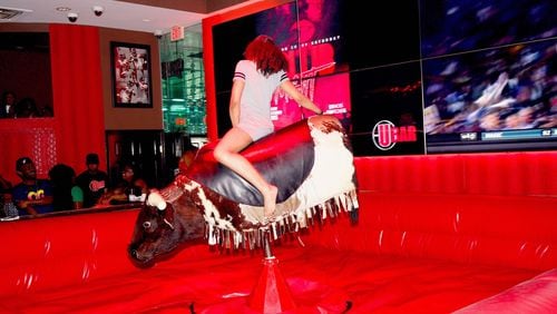A patron of The U Bar in East Point rides Mandingo the mechanical bull. The city of East Point shut down U Bar on Sept. 20, but the restaurant and sports bar intends to open soon. (Photo courtesy of Alre Alston)