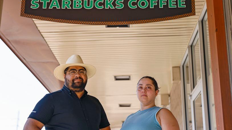 Shift supervisors Nick Julian and Amanda Rivera stand outside of Starbucks at Ansley Mall where employees will vote to unionize on Wednesday, June 22, 2022. (Natrice Miller / natrice.miller@ajc.com)