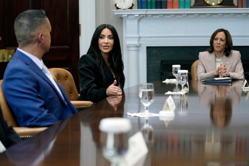 Vice President Kamala Harris, right, listens as Kim Kardashian, center, speaks during a discussion in the Roosevelt Room of the White House in Washington, Thursday, April 25, 2024, on criminal justice reform and the pardons issued by President Joe Biden earlier this month. Jason Hernandez is at left. (AP Photo/Susan Walsh)