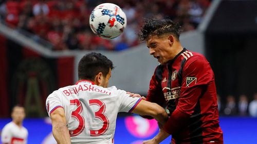 Yamil Asad  (right) of Atlanta United wins a header against Steven Beitashour of Toronto FC at Mercedes-Benz Stadium on October 22, 2017 in Atlanta, Georgia.  (Photo by Kevin C. Cox/Getty Images)
