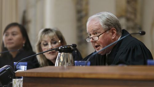 FILE- In this Sept. 18, 2014, file photo, Circuit Judge William A. Fletcher, right, questions Asst. U.S. Atty. Merry Chan about Barry Bonds' conviction before an 11-judge panel of the 9th U.S. Circuit Court of Appeals in San Francisco. The federal appellate court is hearing arguments whether to reinstate President Donald Trump's immigration travel ban. (AP Photo/Eric Risberg, Pool, File)