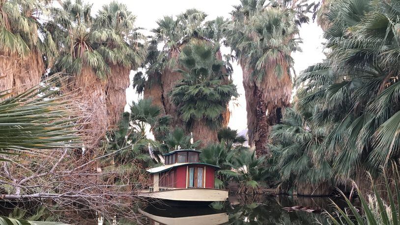 The 9,000-year-old Oasis of Mara and its palm-lined pond — complete with moored houseboat — is the heart of the 29 Palms Inn, which has a restaurant and bungalow rentals. (Jim Buchta/Minneapolis Star Tribune/TNS)