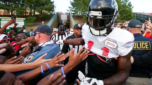Fans reach out for Atlanta Falcons wide receiver Julio Jones (11) during the ninth annual “Kia Motors Friday Night Lights” at Grayson High School, Friday, August 5, 2016, in Loganville, Ga. BRANDEN CAMP/SPECIAL