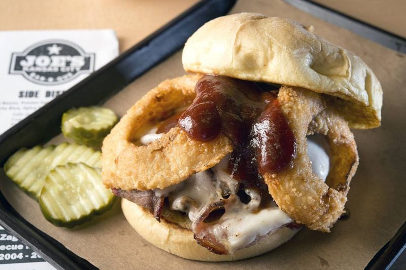 Joe's Kansas City Bar-B-Que's famous Z-Man sandwiches feature slow-smoked beef brisket, smoked provolone cheese and onion rings on a toasted kaiser roll. (Tammy Ljungblad/The Kansas City Star/TNS)