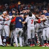 110221 HOUSTON: The Braves charge the mound to celebrate beating the Astros in game 6 to win the World Series on Tuesday, Nov. 2, 2021, in Houston.   “Curtis Compton / Curtis.Compton@ajc.com”