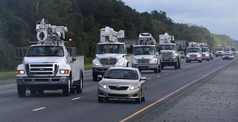A fleet of power trucks head south on I-95 near Jesup to begin restoring power in the aftermath of Hurricane Matthew on Saturday, Oct. 8, 2016. Curtis Compton /ccompton@ajc.com