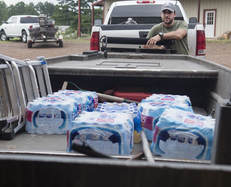 Casey Korkmas of Tyler, Texas, helps pack supplies into a boat at WC Custom Boats in Noonday, Texas where several volunteers met to head to areas affected by Hurricane Harvey Monday morning Aug. 28, 2017. The group took six boats stocked with fuel and water headed to the Houston area to assist in Hurricane Harvey rescue efforts. (Sarah A. Miller/Tyler Morning Telegraph via AP)