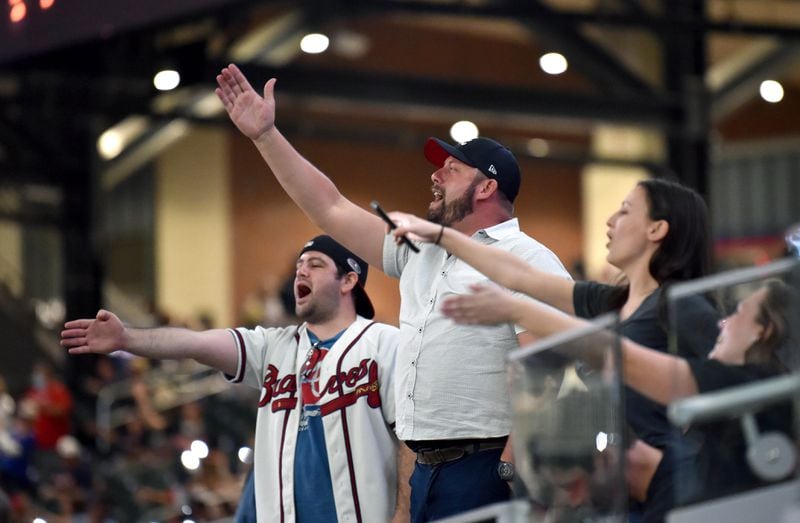 Braves fans perform the "Tomahawk Chop" during Atlanta Braves home opener at Truist Park on Friday. (Hyosub Shin / Hyosub.Shin@ajc.com)