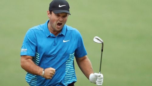 Patrick Reed celebrates his eagle chip on the 15th hole during the third round of the Masters Saturday at Augusta National Golf Club.