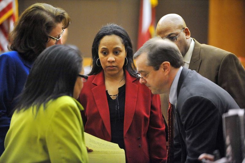 Fulton prosecutor Fani Willis, center, and her colleagues confer during the Atlanta Public Schools test-cheating trial in Fulton County Superior Court on March 19, 2015. (Atlanta Journal-Constitution, Kent D. Johnson, Pool)