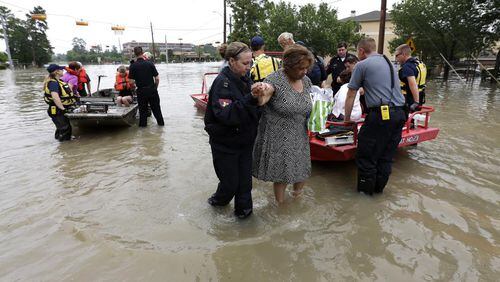 Residents are evacuated from their flooded apartment complex Tuesday, April 19, 2016, in Houston. Storms have dumped more than a foot of rain in the Houston area, flooding dozens of neighborhoods. (AP Photo/David J. Phillip)