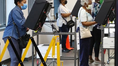 In this file photo, voters wear masks and cast their ballots at least six feet apart the first day of early voting at the Cobb County Board of Elections' Registration on Monday afternoon, May 18, 2020, in Marietta, Ga. (Curtis Compton/Atlanta Journal-Constitution/TNS)