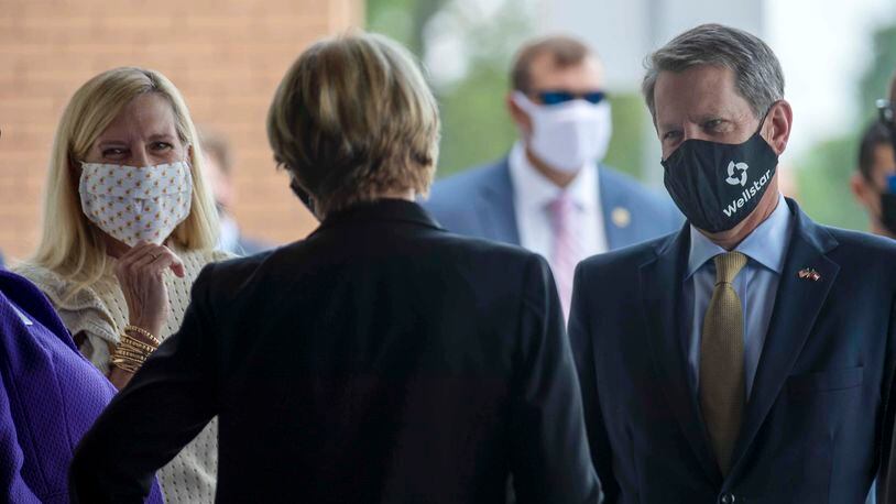 07/16/2020 - Marietta, Georgia - Wearing face masks, Gov. Brian Kemp and First Lady Marty Kemp are greeted as they arrived to the ribbon cutting ceremony for the new Wellstar Kennestone Hospital Emergency Department building in Marietta, Thursday, July 16, 2020. (ALYSSA POINTER / ALYSSA.POINTER@AJC.COM)