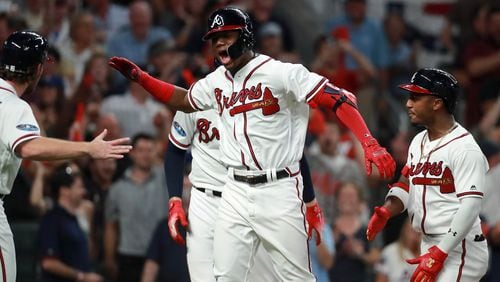 Atlanta Braves left fielder Ronald Acuna reacts after hitting a grand slam home run in the second inning against the Los Angeles Dodgers in Game 3 of a National League Division Series baseball game Sunday, October 7, 2018, in Atlanta. Curtis Compton/ccompton@ajc.com
