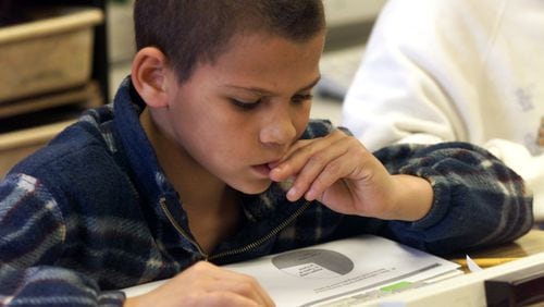A fourth grader works on an exercise to prepare him for the state proficiency test.