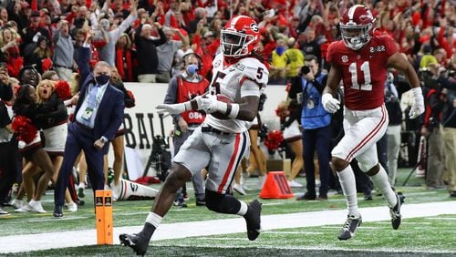 Georgia defensive back Kelee Ringo intercepts Alabama and returns it for a touchdown for a 33-18 lead and victory over Alabama in the College Football Playoff Championship game on Monday, Jan. 10, 2022, in Indianapolis.  “Curtis Compton / Curtis.Compton@ajc.com”`