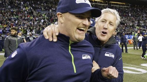 Seattle Seahawks head coach Pete Carroll, right, celebrates with defensive coordinator Dan Quinn, left, after they defeated the St. Louis Rams 20-6 in an NFL football game, Sunday, Dec. 28, 2014, in Seattle. (AP Photo/Scott Eklund)